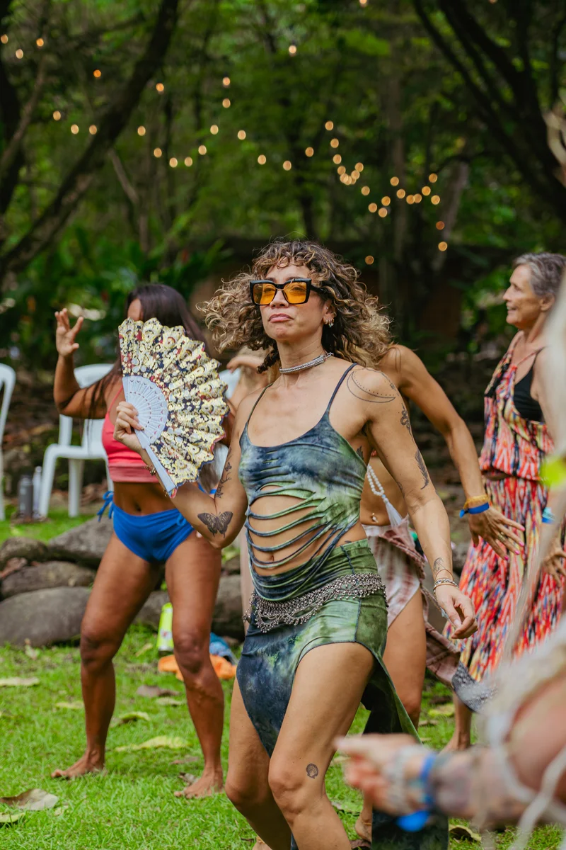 Dancing outdoors on the lawn under string lights